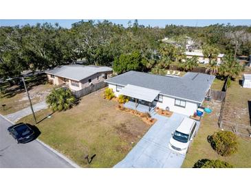 Aerial view of a charming house with a spacious yard and a pool at 1344 Springdale St, Clearwater, FL 33755