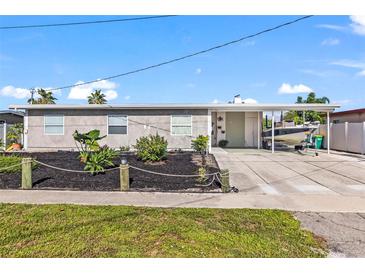 Ranch style home with carport and nicely landscaped front yard at 4086 Gardner Dr, Port Charlotte, FL 33952