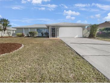 Single-story home with a well-maintained lawn and attached garage at 2092 Nuremberg Blvd, Punta Gorda, FL 33983