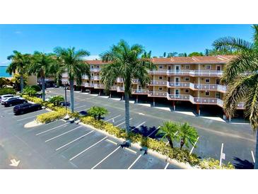 Two-story condo building with parking and tropical landscaping at 1420 Bayshore Blvd # 316, Dunedin, FL 34698