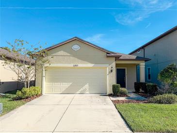 Single-story house with a two-car garage and landscaped lawn at 1403 Custer Bayou St, Ruskin, FL 33570