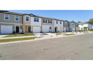 New townhome community with attached garages and well-manicured landscaping at 6188 Pina Colada St, Zephyrhills, FL 33542