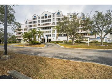 White building with blue accents, landscaping, and ample parking at 2333 Feather Sound Dr # A101, Clearwater, FL 33762