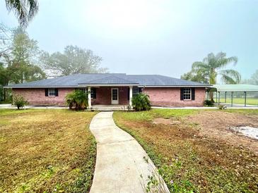 Brick ranch house with a walkway and carport at 2105 Vickery Ln, Dover, FL 33527