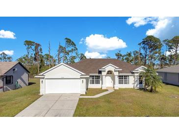 Single-story house with a white exterior, a two-car garage, and a neatly landscaped lawn at 14248 Salvatierra Ln, Port Charlotte, FL 33981