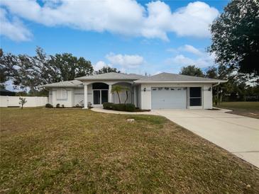 Single-story home with attached garage and well-maintained lawn at 13 Perimeter Dr, Englewood, FL 34223