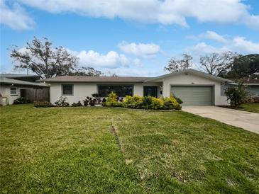 Charming single story home with a well manicured lawn and green garage door at 2801 65Th N Way, St Petersburg, FL 33710