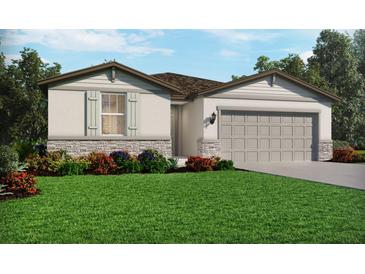 One-story home with stone accents, landscaped lawn, and two-car garage at 125 Blue Beach St, Nokomis, FL 34275