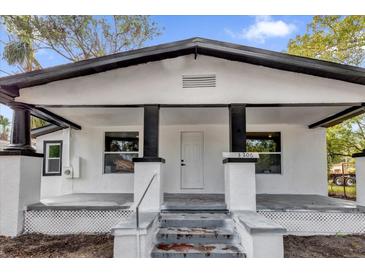 White house with black accents, front porch, and steps at 3206 N 29Th St, Tampa, FL 33605