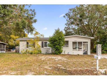 Charming single-story home with a well-maintained lawn and mature trees at 1621 S Jefferson Ave, Clearwater, FL 33756