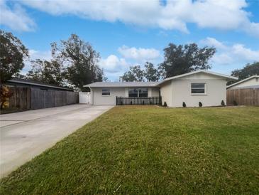 Updated single story home with a well-manicured lawn and driveway at 5339 Brookmeade Dr, Sarasota, FL 34232