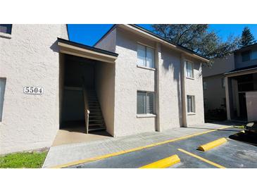 Exterior view of condo building with stairs leading to unit 5504 at 5504 Pokeweed Ct # 154, Tampa, FL 33617