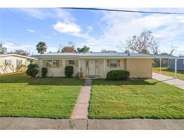 Cute ranch home with carport, nicely landscaped lawn, and walkway at 6540 Marius Rd, North Port, FL 34287