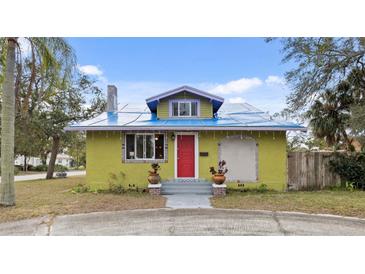 Charming bungalow with a red door, unique exterior, and landscaped yard at 3000 21St S Ave, St Petersburg, FL 33712