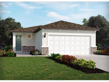 One-story home with a two-car garage and landscaping at 1860 Brekey Way, Zephyrhills, FL 33541