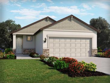 One-story home with a two-car garage and landscaping at 1877 Brekey Way, Zephyrhills, FL 33541