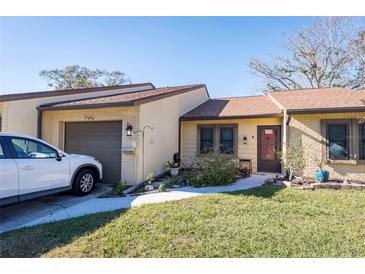 Cute condo with a one-car garage and small front yard at 2101 Sunset Point Rd # 2304, Clearwater, FL 33765