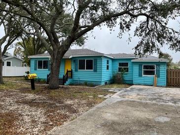 Charming light blue house with a well-maintained yard at 732 Riverside Dr, Tarpon Springs, FL 34689