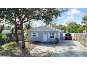 Cute bungalow with a gray exterior, fenced yard, and driveway at 510 S Disston Ave, Tarpon Springs, FL 34689