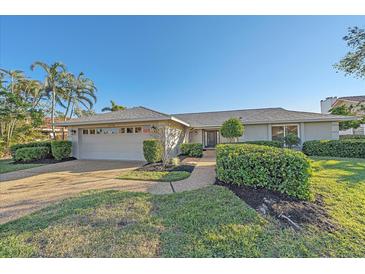 Single-story home with a two-car garage and well-manicured landscaping at 3770 Torrey Pines Blvd, Sarasota, FL 34238