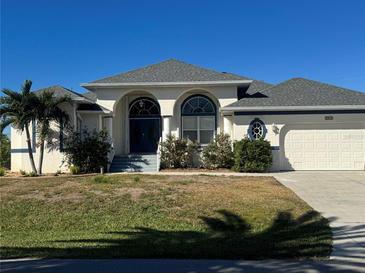 Single-story home with a gray roof, white walls, and a two-car garage at 2917 Palm Dr, Punta Gorda, FL 33950