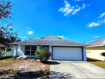 Charming single-Gathering home featuring an attached two-car garage and a well-maintained front yard at 2022 Peaceful Palm St, Ruskin, FL 33570