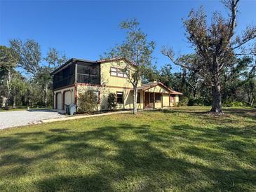 Two-story house with a screened porch, attached garage, and spacious yard at 7027 Hawkins Rd, Sarasota, FL 34241