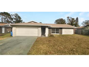 Charming single-story home with a well-maintained front yard and attached two-car garage at 14315 Knoll Ridge Dr, Tampa, FL 33625