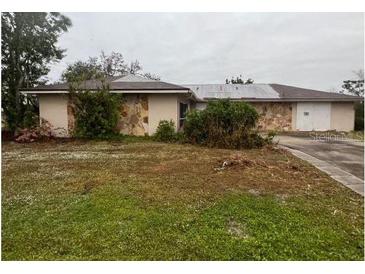 Ranch style home with mature landscaping and large yard at 23102 Maclellan Ave, Port Charlotte, FL 33980