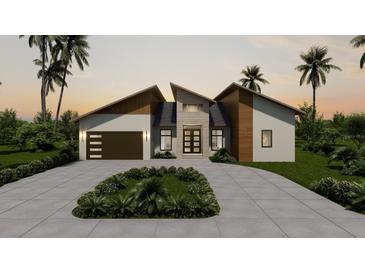 Modern home exterior with two-car garage and landscaping at 9468 Attica Cir, Port Charlotte, FL 33981
