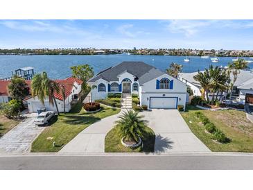 Beautiful waterfront home featuring an attached two car garage, with lovely landscaping and water views at 6354 Cocoa Ln, Apollo Beach, FL 33572