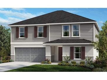 Charming two-story home showcasing gray siding, complemented by a well-manicured lawn and a two car garage at 19980 Azul Marble Loop, Land O Lakes, FL 34638