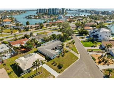 Beautiful aerial view of a neighborhood with waterfront homes near a large bay and modern condos at 10111 Yacht Club Dr, Treasure Island, FL 33706