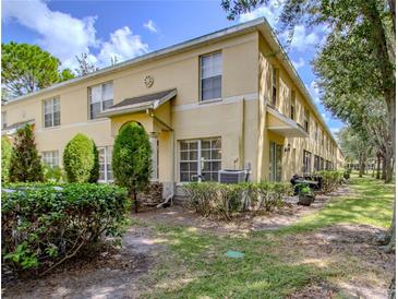 Charming townhouse featuring a well-manicured lawn and inviting facade at 10917 Brickside Ct, Riverview, FL 33579