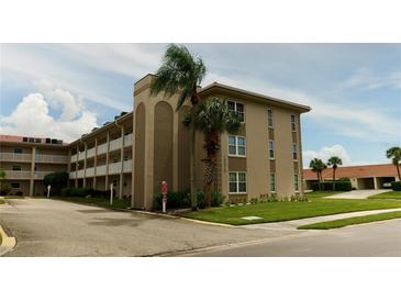 Two-story condo building with balconies and lush landscaping at 10215 Regal Dr # 19, Largo, FL 33774