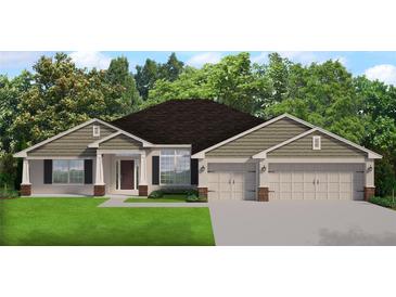 One-story home with neutral siding, two-car garage, and landscaping at 15057 Missouri Skylark Rd, Weeki Wachee, FL 34614