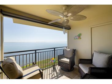 Relaxing balcony seating with beautiful water views, overhead fan, and tiled flooring at 6372 Palma Del Mar S Blvd # Apt 307, St Petersburg, FL 33715