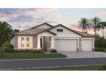 Two-story home with gray siding, tile roof, and two-car garage at 1504 Lugano Cir, Nokomis, FL 34275