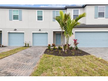 Townhouse exterior with light blue garage doors at 5410 Tripoli Dr, Palmetto, FL 34221