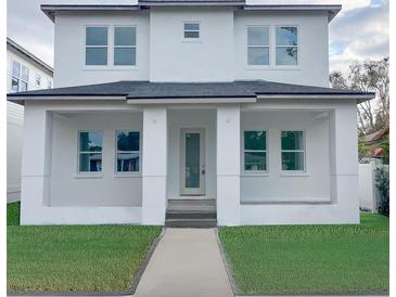 Two-story home with white exterior and a landscaped lawn at 820 46Th N Ave, St Petersburg, FL 33703