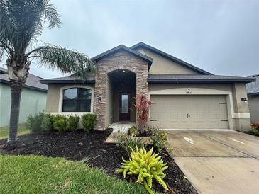 One-story home with stone accents and a two-car garage at 11854 Thicket Wood Dr, Riverview, FL 33579