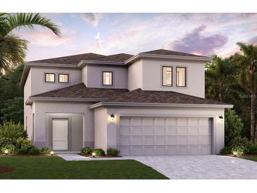 Two-story house with a two-car garage and landscaping at 16896 Fiesta Dr, Port Charlotte, FL 33953