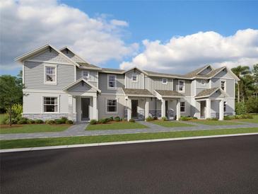 Three-unit townhome building with gray siding, stone accents, and front porches at 1885 Bilge Ln, Sarasota, FL 34240