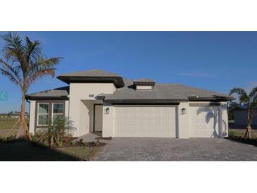 Two-story home with a two-car garage and landscaped yard at 2036 Bolsena St, Nokomis, FL 34275