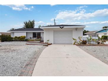 White single-story house with a garage and landscaped yard at 6628 Keystone Dr, Sarasota, FL 34231