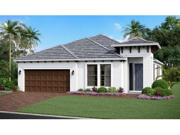 Charming single-story home featuring a two-car garage, well-manicured lawn, and tasteful landscaping at 17150 Savory Mist Cir, Bradenton, FL 34211