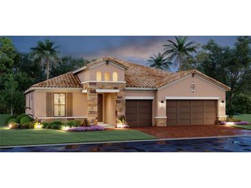 Beautiful single-Gathering home with a tile roof, three-car garage, stone accents, and lush landscaping at 4719 Cassonade Cv, Bradenton, FL 34211