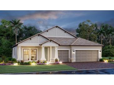 Charming single-story home featuring a two-car garage, manicured lawn and neutral-toned exterior at 4720 Sweet Retreat Run, Bradenton, FL 34211