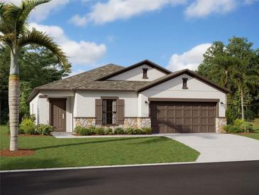 Charming single-story home with stone accents, a well-manicured lawn, and a two-car garage at 9872 Last Light Gln, Parrish, FL 34219
