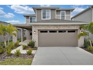Two-story home with stone accents and two-car garage at 5943 Jensen View Ave, Apollo Beach, FL 33572